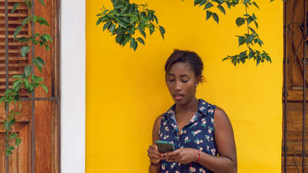 Young Afro-American woman, dressed in colors, in the city of Cali, Valle del Cauca, Colombia. Single, young woman.の写真素材