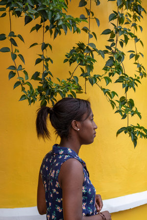 Young Afro-American woman, dressed in colors, in the city of Cali, Valle del Cauca, Colombia....