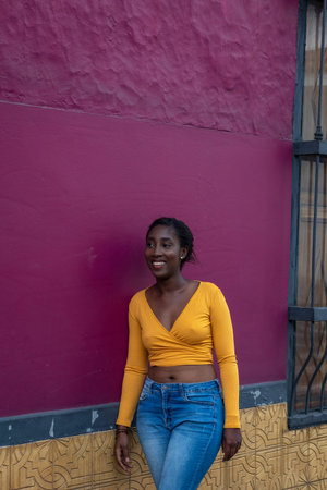 Young Afro-American woman, dressed in colors, in the city of Cali, Valle del Cauca, Colombia....