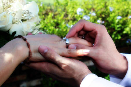 hands with bouquet of flowers of newlywedsの写真素材
