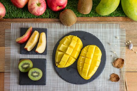 Variety of Cut Fruits on Wooden Tableの写真素材