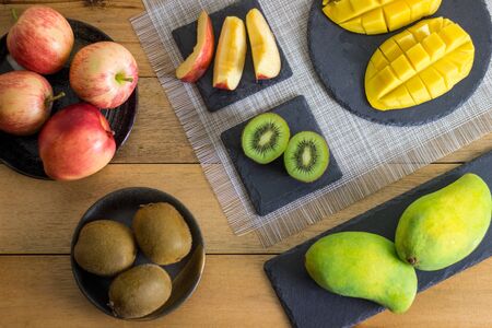 Variety of Cut Fruits on Wooden Tableの写真素材
