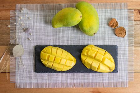 Freshly Sliced Mango on Wooden Tableの写真素材
