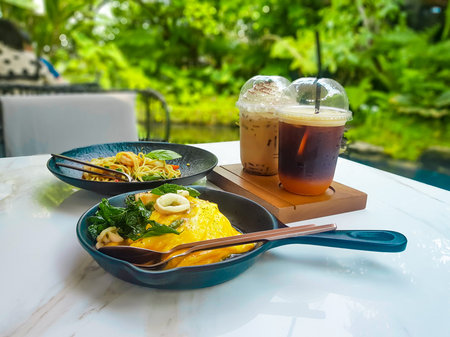Tables with food and drinks in a restaurant in the midst of nature.