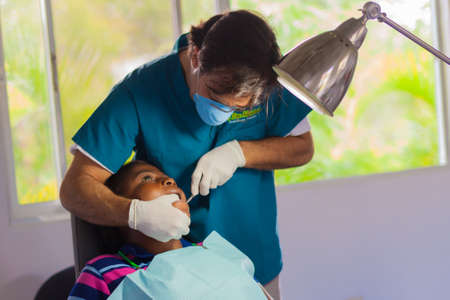 SosÃºa, Puerto Plata Province, Dominican Republic - May 11, 2013: Volunteer dentist working on child in Dominican Republic at Monkey Jungle medical facility.のeditorial素材