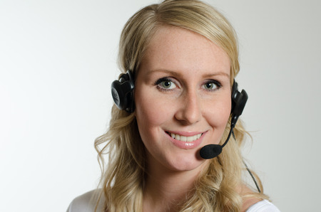 Woman, young, beautiful, selfconfident, blonde attractive, healthy, successful, female, curly hair, modern, business, business woman, career, promotion, headset, phone, phone call, telemarketing, marketing,の写真素材