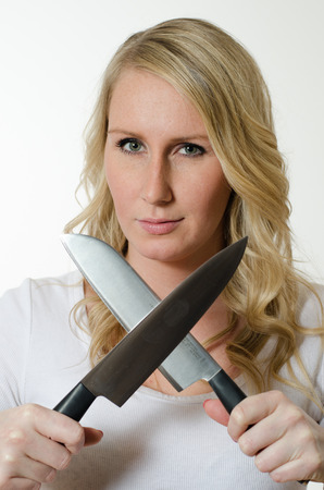 young woman sharpens knifesの写真素材