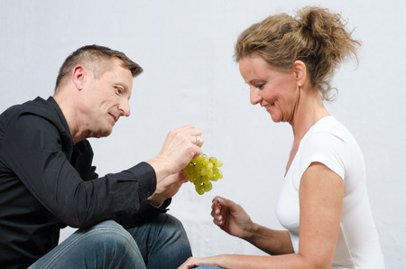 couple eating grapesの写真素材