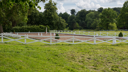 nice view on an empty riding place with white fenceの写真素材