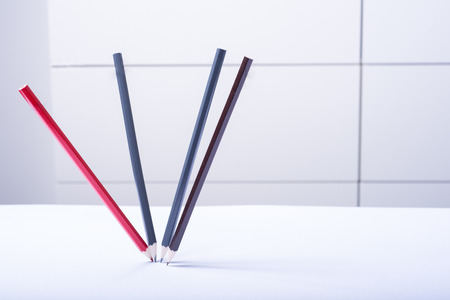 four dancing pencils as still life on white backgroundの写真素材
