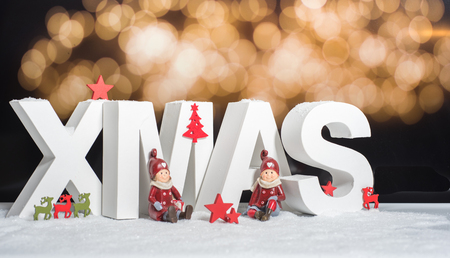 XMAS in white letter with blurred light backgroundの写真素材