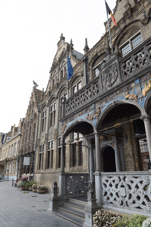 Historic town hall with flags and gold jewelry in Voerne, Belgiumの写真素材