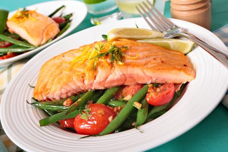Grilled salmon steak with green beans and cherry tomatoesの写真素材