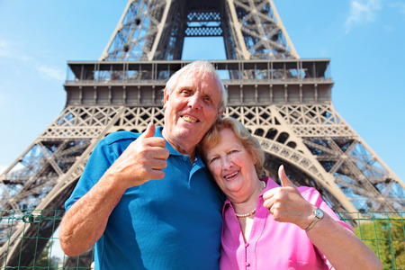 Senior couple enjoying their vacation in front of Eiffel Tower in Parisの写真素材