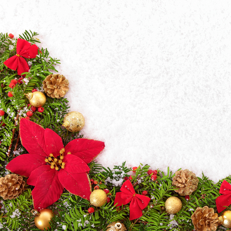 Christmas border with traditional decorationsand poinsettia on the snow squareの写真素材