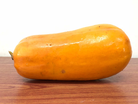 The orange papaya on the wood