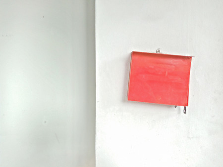 Red postbox on old white wallの写真素材