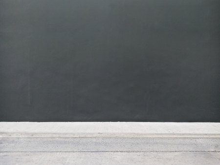 Dark black wall and white concrete floor on streetの写真素材