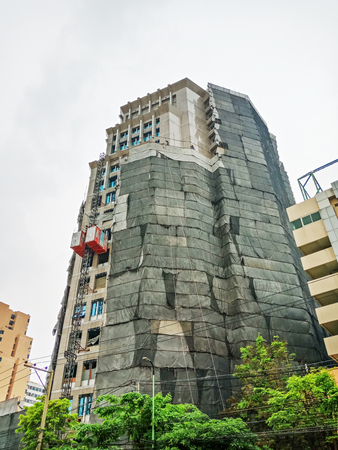 Tower building under construction with white sky in Thailandのeditorial素材