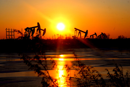Oil pump jacks over sunset backgroundの写真素材