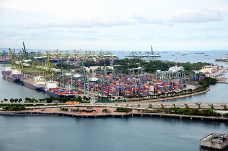 The container cargo vessel is docked in The port of Alicante working with containers crane
