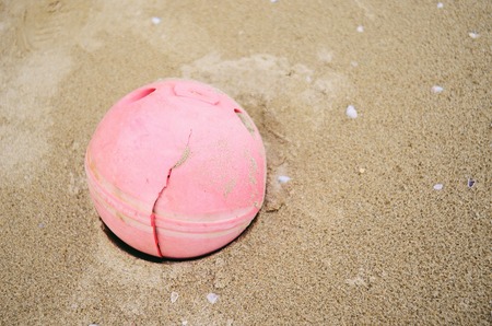 Round pink ball on the beach