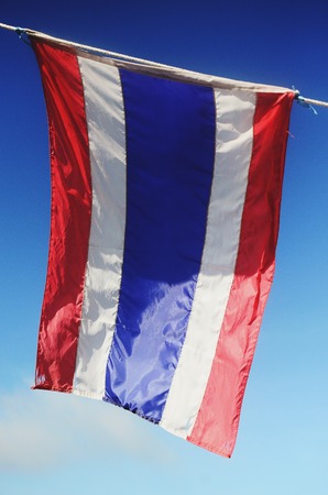 Image of waving Thai flag of Thailand with blue sky background