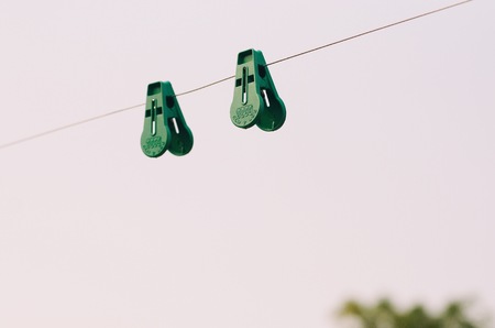 Clothespins hang on a cord