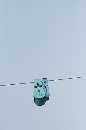 Clothespins hang on a cordの写真素材