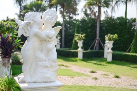 Cupid statue in gardenの写真素材