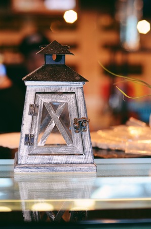 lamp with a candle standing on the tableの写真素材