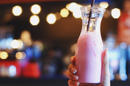 Pink milk in glass bottlesの写真素材