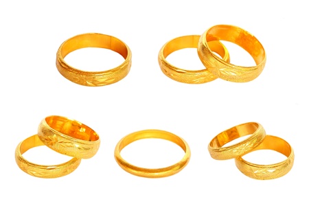 couple of gold wedding rings on white backgroundの写真素材