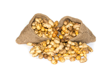 peanuts in a miniature burlap bag isolated on white 