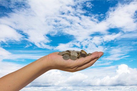 Hand holding coinsの写真素材