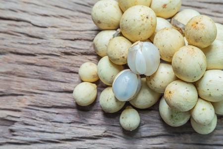 Fresh Lansium domesticum on a wooden floor and has a background of nature