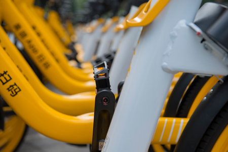 A partial close-up of a shared bicycle parked on a city street. The Chinese on the bicycle is "scan code"の写真素材
