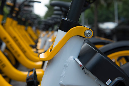 A partial close-up of a shared bicycle parked on a city street. The Chinese on the bicycle is "scan code"の写真素材