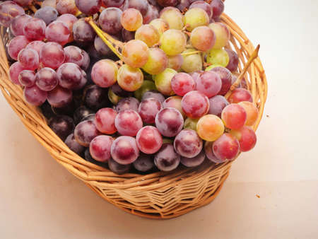 Red grapes in the fruit basket, White background