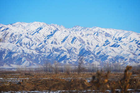 Farmland after snow in winter, snow mountain