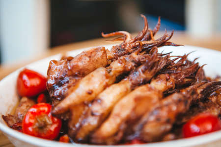 Spicy squid, delicious and juicy on the plate, seafood dishesの写真素材