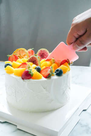 Round cake with fruit decoration, Colorful, white cream