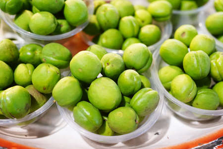 Street food green apricots, Sour fruitの写真素材