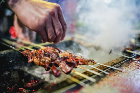 Grilling lamb kebabs on the barbecueの写真素材