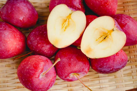 Indoor red small apple cut, beautiful fresh juicy fruitの写真素材