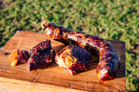 Horse meat and sausage cooked on the prairieの写真素材