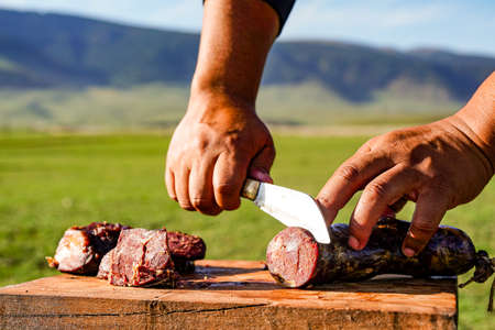 Horse meat and sausage cooked on the prairieの写真素材