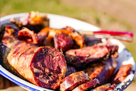 Horse meat and sausage cooked on the prairieの写真素材