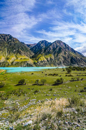 The scenery of the blue lake surrounded by mountainsの写真素材