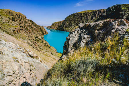 The scenery of the blue lake surrounded by mountainsの写真素材